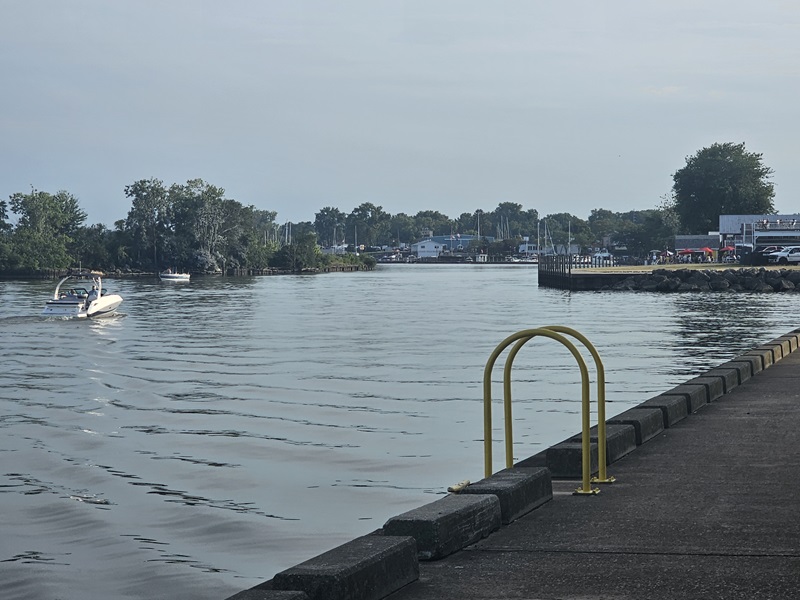Sunset view of the Huron Pier, with the sun getting low and reflecting off the water