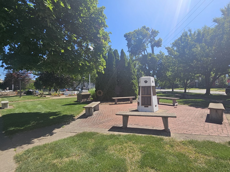 View of one of the park's suspended sculptures, of a man sitting and holding rowing oars