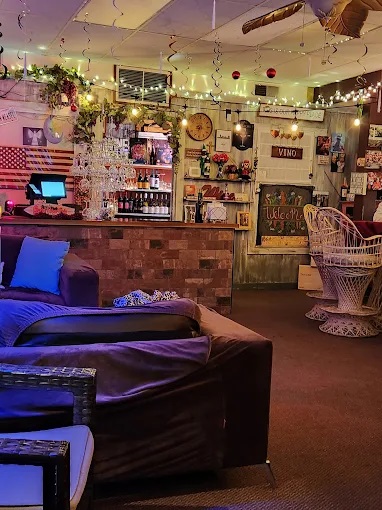 View of the ordering counter with wine bottles in the background and a glimpse of a couch in the foreground