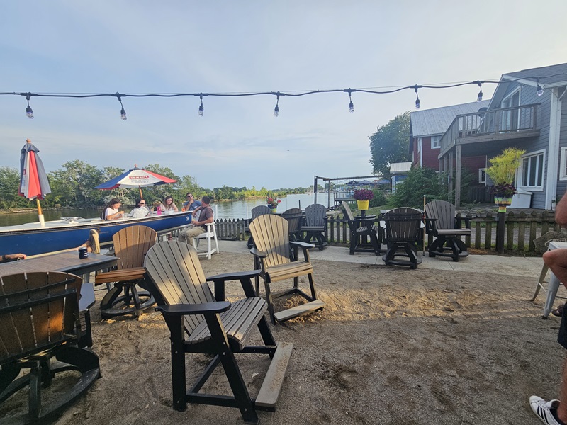 Back view of the Old Fish House buildings and the sandy ground of the patio