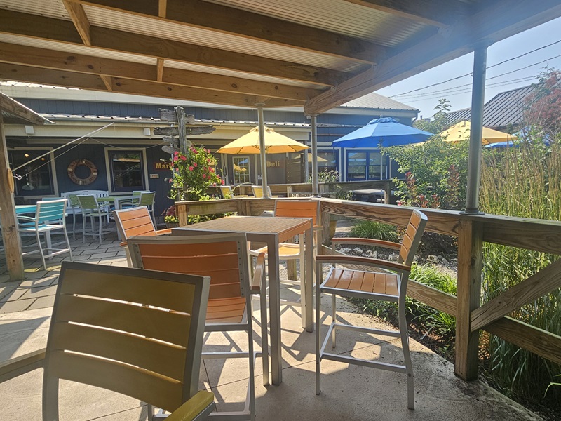 View of Rudder's patio, with colorful tables, chairs, and umbrellas
