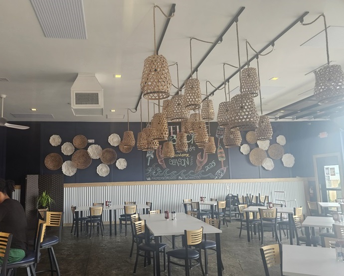View of Pipe Creek Wharf's dining room, with modern decor and suspended ceiling fixtures